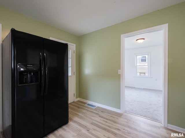 1108 Mechanic St, Pekin, IL 61554 - kitchen featuring black refrigerator with ice dispenser and light wood-type flooring