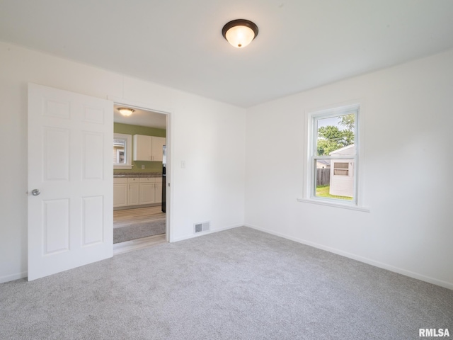 1108 Mechanic St, Pekin, IL 61554 - unfurnished room with light carpet and baseboards