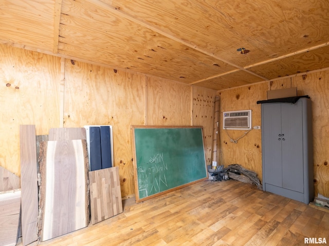 21218 E County Highway 17, Canton, IL 61520 - spare room with a wall mounted AC, wood finished floors, and wooden walls