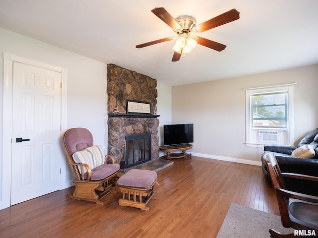 21218 E County Highway 17, Canton, IL 61520 - living room with a fireplace, wood finished floors, a ceiling fan, and cooling unit