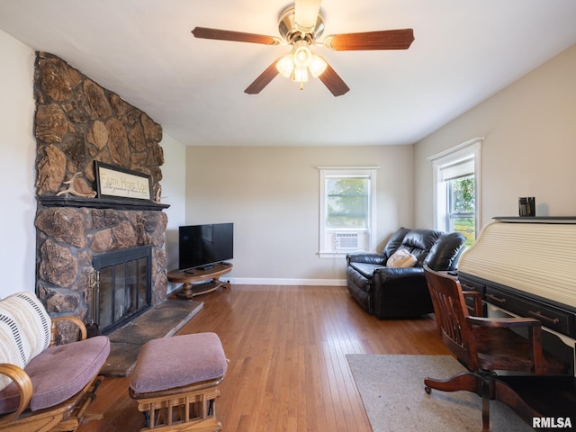 21218 E County Highway 17, Canton, IL 61520 - living room with hardwood / wood-style flooring, a stone fireplace, ceiling fan, and cooling unit