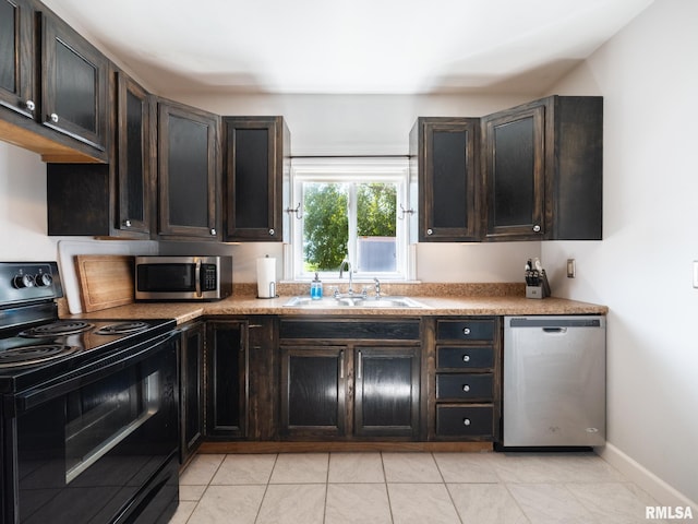 21218 E County Highway 17, Canton, IL 61520 - kitchen featuring appliances with stainless steel finishes, light tile patterned flooring, and dark brown cabinetry