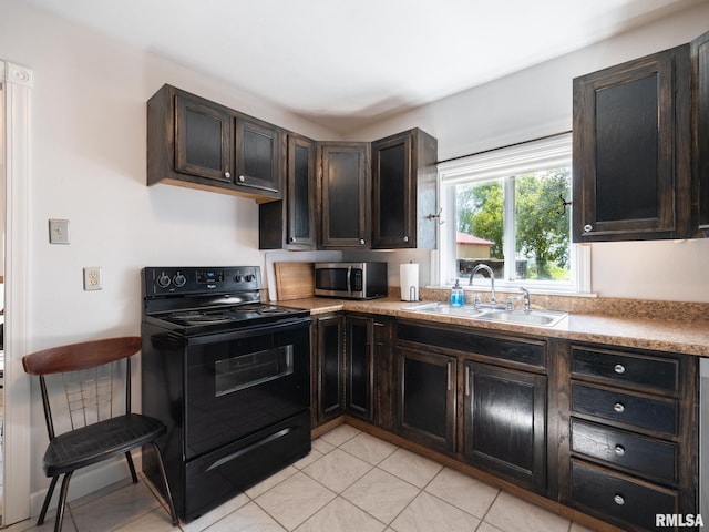 21218 E County Highway 17, Canton, IL 61520 - kitchen with black / electric stove, stainless steel microwave, dark brown cabinets, and light countertops