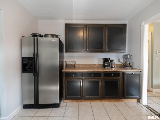 21218 E County Highway 17, Canton, IL 61520 - kitchen with stainless steel fridge, dark brown cabinets, light tile patterned floors, and light countertops