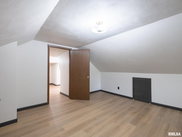 21218 E County Highway 17, Canton, IL 61520 - additional living space featuring light wood finished floors, lofted ceiling, and a textured ceiling