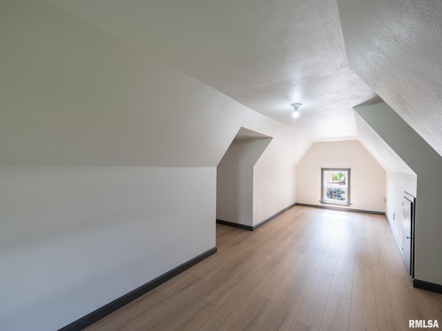 21218 E County Highway 17, Canton, IL 61520 - bonus room with wood finished floors, lofted ceiling, and a textured ceiling