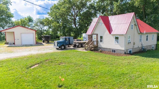 21218 E County Highway 17, Canton, IL 61520 - view of property exterior featuring a detached garage, an outdoor structure, dirt driveway, a metal roof, and a yard