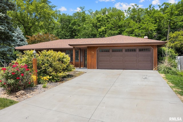 112 Iron Bark Ct, East Peoria, IL 61611 - view of front of home featuring driveway, an attached garage, a chimney, and roof with shingles