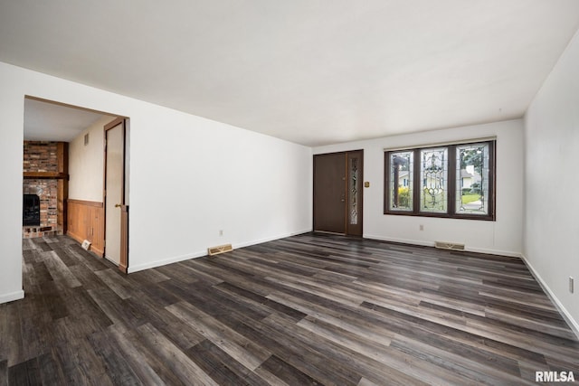 112 Iron Bark Ct, East Peoria, IL 61611 - unfurnished living room featuring dark wood-style flooring and a fireplace