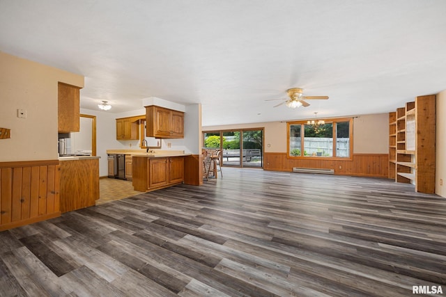 112 Iron Bark Ct, East Peoria, IL 61611 - unfurnished living room with a baseboard radiator, wainscoting, ceiling fan, dark wood finished floors, and wood walls