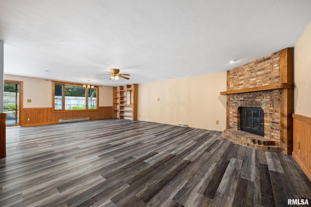 112 Iron Bark Ct, East Peoria, IL 61611 - unfurnished living room featuring wainscoting, ceiling fan, a brick fireplace, wood finished floors, and plenty of natural light
