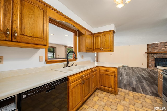 112 Iron Bark Ct, East Peoria, IL 61611 - kitchen with dishwasher, brown cabinetry, light countertops, a fireplace, and open floor plan