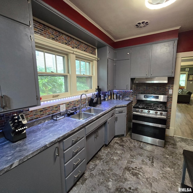 211 E Frye Ave, Peoria, IL 61603 - kitchen featuring stainless steel gas range, gray cabinetry, under cabinet range hood, tasteful backsplash, and ornamental molding