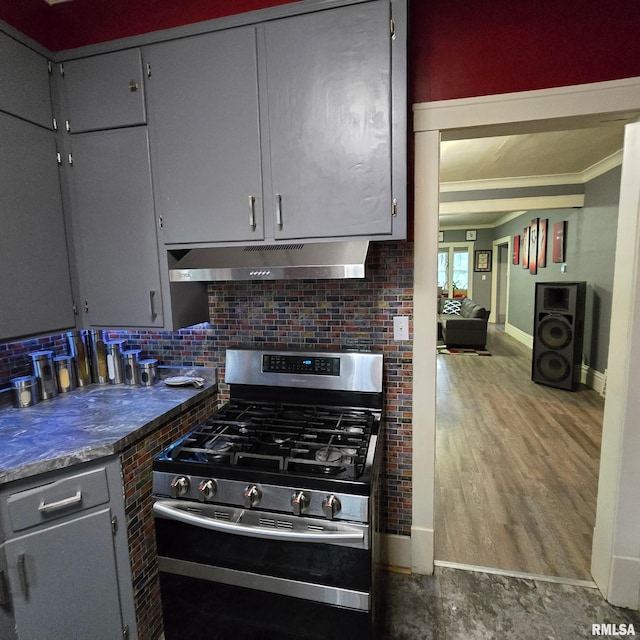 211 E Frye Ave, Peoria, IL 61603 - kitchen with stainless steel gas range, under cabinet range hood, backsplash, crown molding, and gray cabinetry