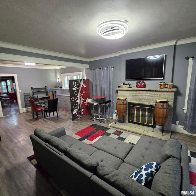 211 E Frye Ave, Peoria, IL 61603 - living area with crown molding, healthy amount of natural light, a stone fireplace, and wood finished floors