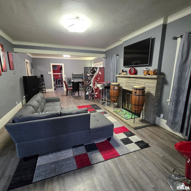 211 E Frye Ave, Peoria, IL 61603 - living area featuring wood finished floors, crown molding, and a stone fireplace