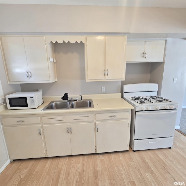 2029 W Forrest Hill Ave, Peoria, IL 61604 - kitchen with white appliances, light wood-style floors, light countertops, and white cabinetry