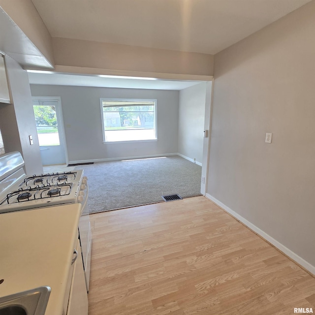 2029 W Forrest Hill Ave, Peoria, IL 61604 - kitchen featuring white range with gas stovetop and light wood-style flooring