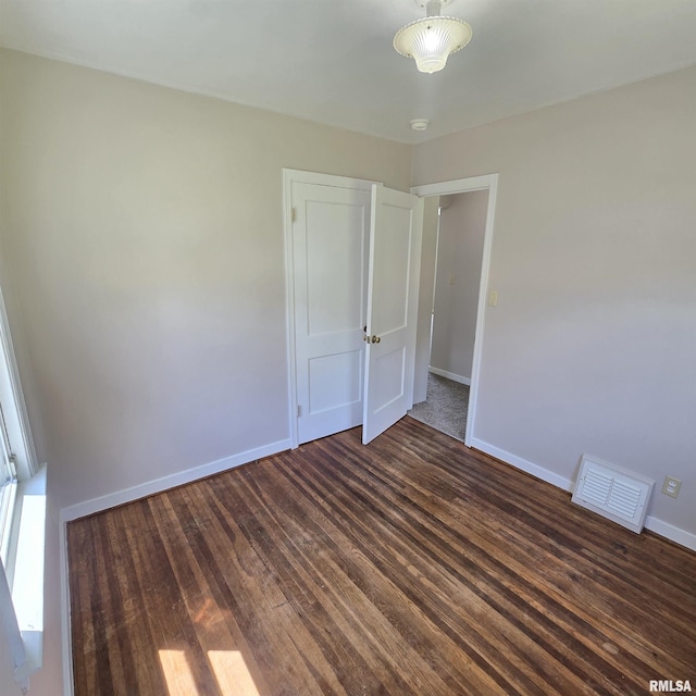 2029 W Forrest Hill Ave, Peoria, IL 61604 - unfurnished bedroom with baseboards and dark wood-style floors