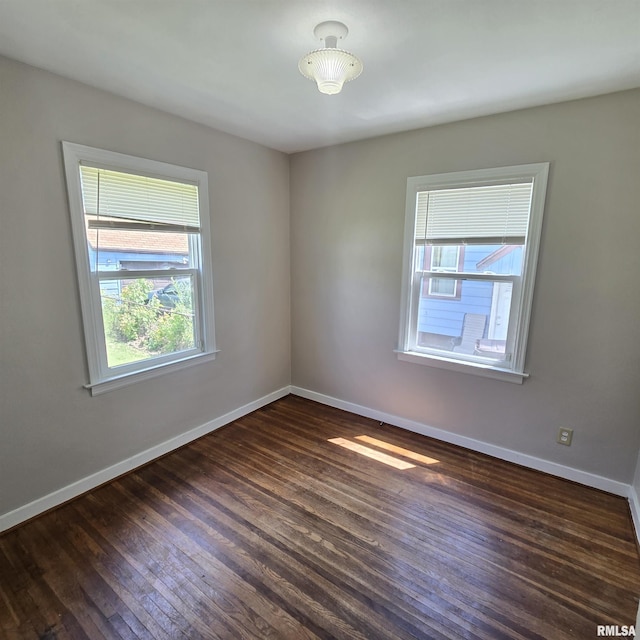 2029 W Forrest Hill Ave, Peoria, IL 61604 - spare room with baseboards and dark wood-style flooring