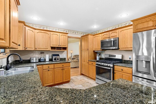 5408 N Rothmere Dr, Peoria, IL 61615 - kitchen featuring stainless steel appliances, a high end fireplace, stone tile flooring, a textured ceiling, and open floor plan