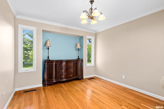 5408 N Rothmere Dr, Peoria, IL 61615 - spare room featuring a chandelier, light wood-style flooring, and ornamental molding