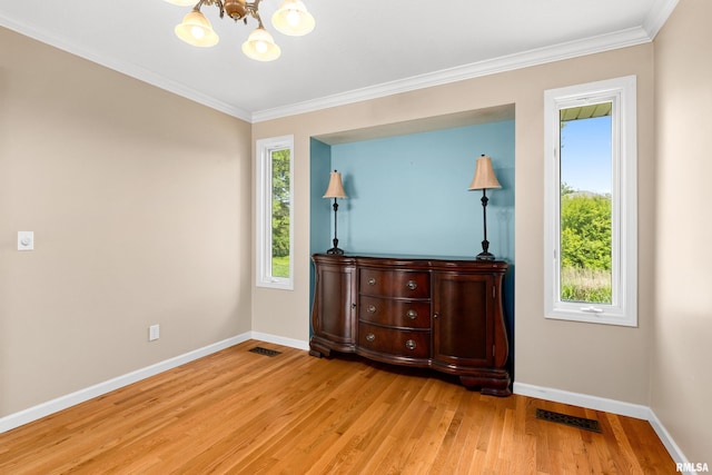 5408 N Rothmere Dr, Peoria, IL 61615 - empty room with a chandelier, light wood finished floors, and ornamental molding