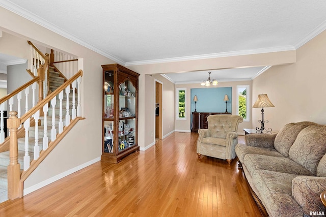 5408 N Rothmere Dr, Peoria, IL 61615 - living room featuring light wood-type flooring, stairway, crown molding, and a chandelier