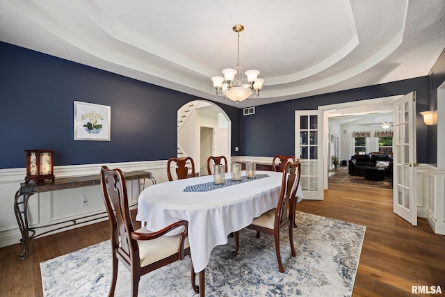88 Waldheim Rd, Morton, IL 61550 - dining area with arched walkways, french doors, a chandelier, wainscoting, and a tray ceiling