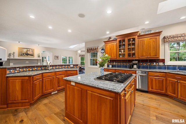 88 Waldheim Rd, Morton, IL 61550 - kitchen featuring a center island, stainless steel gas cooktop, light wood finished floors, brown cabinetry, and recessed lighting