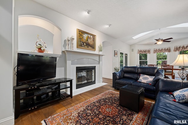 88 Waldheim Rd, Morton, IL 61550 - living area featuring a ceiling fan, lofted ceiling, wood finished floors, a skylight, and a glass covered fireplace