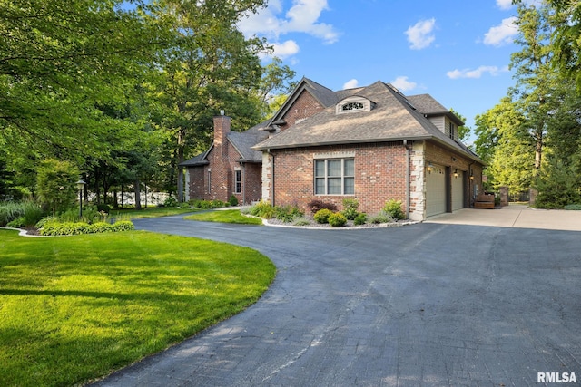 88 Waldheim Rd, Morton, IL 61550 - view of front of property featuring driveway, a front yard, brick siding, a shingled roof, and a chimney