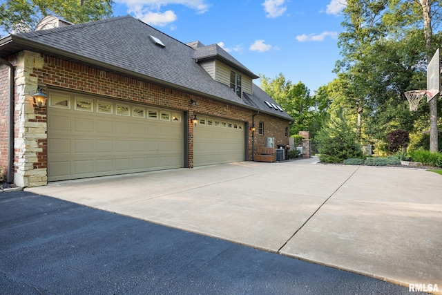 88 Waldheim Rd, Morton, IL 61550 - view of side of home featuring asphalt driveway, brick siding, an attached garage, and a shingled roof