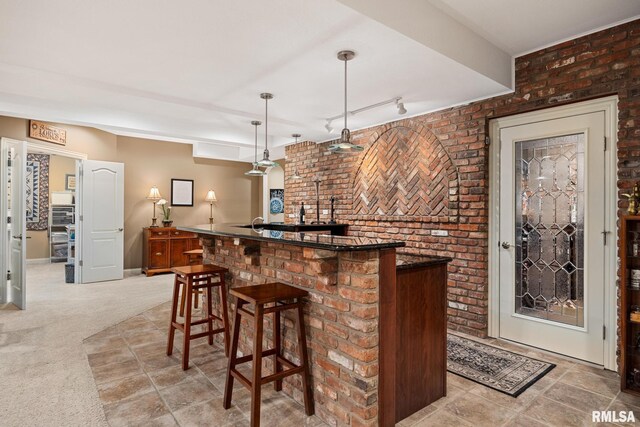 88 Waldheim Rd, Morton, IL 61550 - indoor bar featuring hanging light fixtures, brick wall, light carpet, and rail lighting