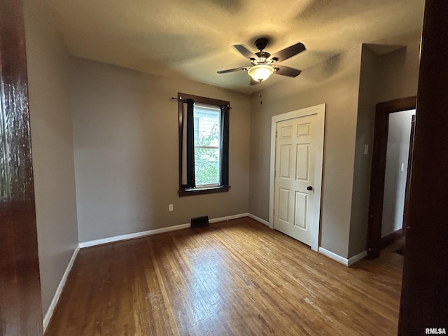 1208 S 13th St, Pekin, IL 61554 - unfurnished bedroom with wood finished floors and a ceiling fan