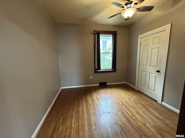 1208 S 13th St, Pekin, IL 61554 - unfurnished bedroom featuring wood finished floors and a ceiling fan