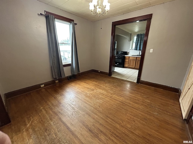 1208 S 13th St, Pekin, IL 61554 - empty room with a chandelier and light wood-style floors