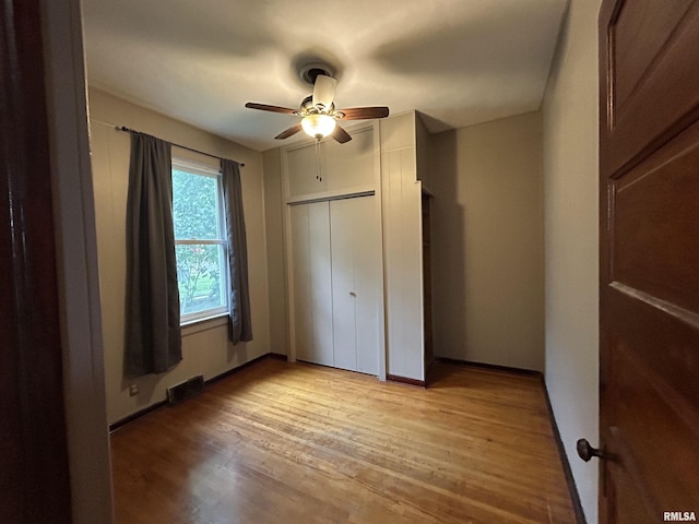 1208 S 13th St, Pekin, IL 61554 - unfurnished bedroom with light wood-style floors, ceiling fan, and a closet