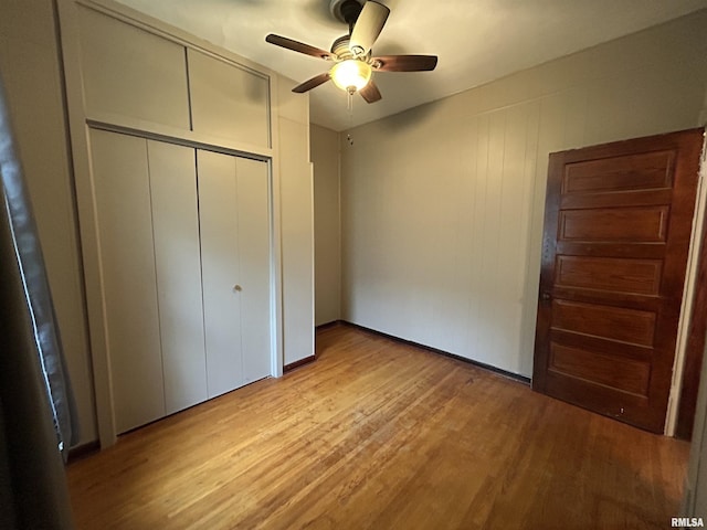1208 S 13th St, Pekin, IL 61554 - unfurnished bedroom featuring light wood finished floors, a closet, and ceiling fan