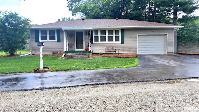 751 N 3rd St, Cuba, IL 61427 - single story home featuring asphalt driveway, a garage, and a front yard