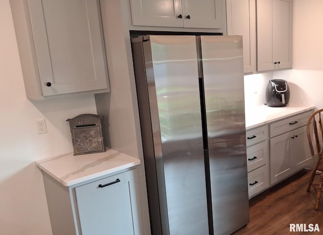 751 N 3rd St, Cuba, IL 61427 - kitchen featuring freestanding refrigerator, dark wood-style flooring, and light stone countertops