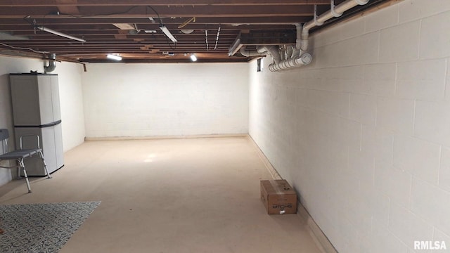 751 N 3rd St, Cuba, IL 61427 - below grade area featuring freestanding refrigerator and concrete block wall