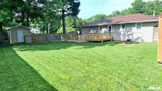 751 N 3rd St, Cuba, IL 61427 - rear view of property with a fenced backyard, a storage unit, a wooden deck, and a shingled roof