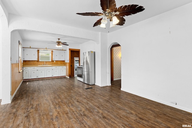 1603 Willow St, Pekin, IL 61554 - unfurnished living room with arched walkways, ceiling fan, and dark wood finished floors