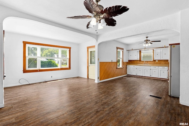 1603 Willow St, Pekin, IL 61554 - unfurnished living room featuring ceiling fan, arched walkways, and dark wood-style floors