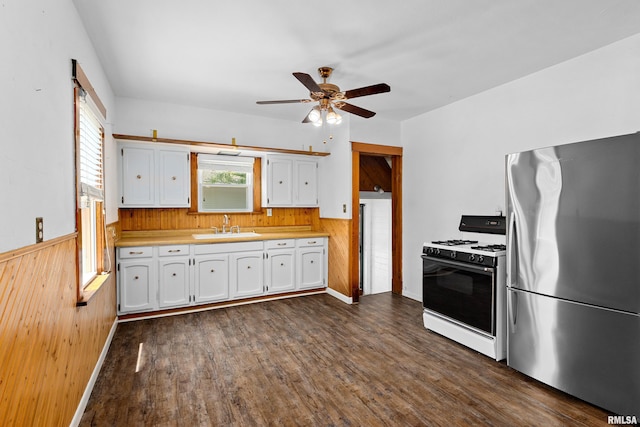 1603 Willow St, Pekin, IL 61554 - kitchen with freestanding refrigerator, gas range gas stove, white cabinetry, light countertops, and a ceiling fan