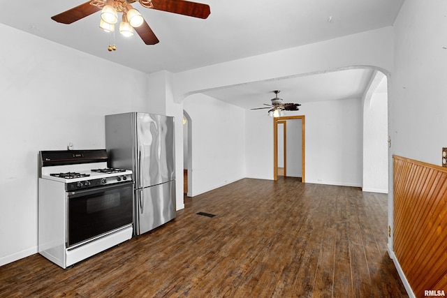1603 Willow St, Pekin, IL 61554 - kitchen with white range with gas cooktop, arched walkways, ceiling fan, and freestanding refrigerator