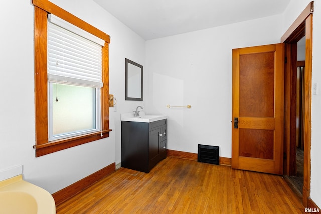 1603 Willow St, Pekin, IL 61554 - bathroom with vanity, wood finished floors, and a tub to relax in