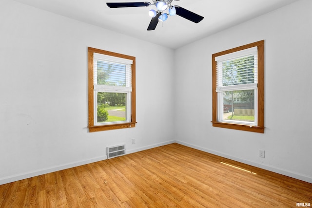 1603 Willow St, Pekin, IL 61554 - empty room featuring plenty of natural light, light wood finished floors, and ceiling fan