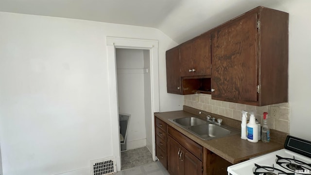 1009 W Armstrong Ave, Peoria, IL 61606 - kitchen featuring white gas range, decorative backsplash, and lofted ceiling